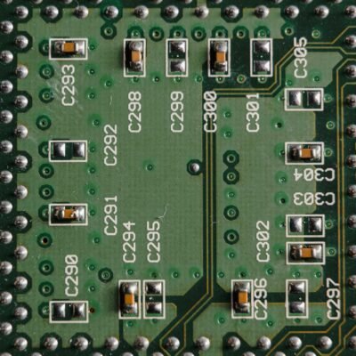 Detailed close-up of a green circuit board featuring microchips and labeled components.