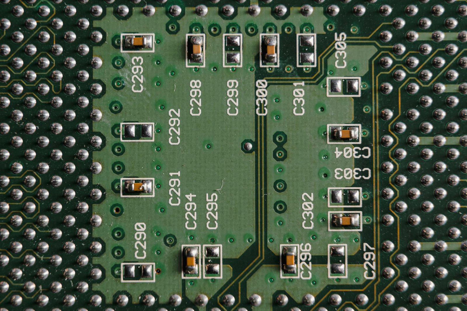 Detailed close-up of a green circuit board featuring microchips and labeled components.