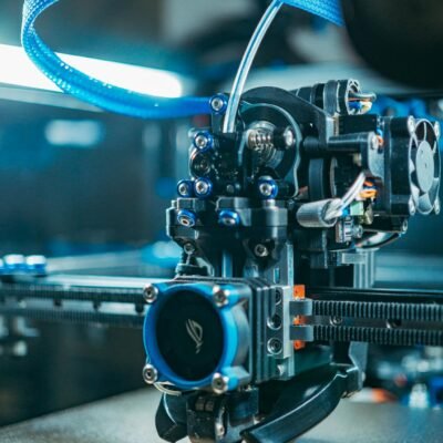 Detailed close-up of a modern 3D printer functioning indoors, showcasing advanced technology.