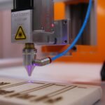 High-tech laser engraving machine working on wooden surface.